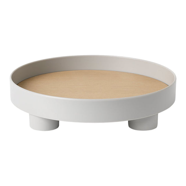 Round white tray with a smooth wood-patterned base and sturdy feet, designed for modern minimalistic decor.