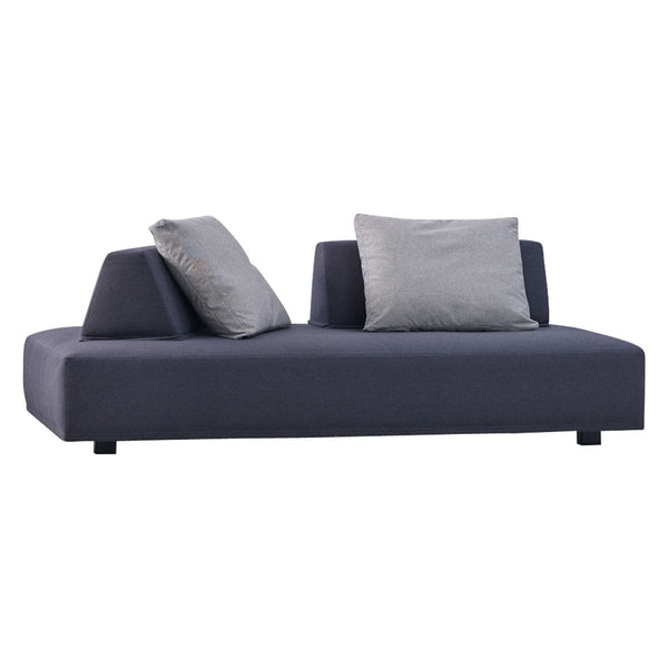 Modern dark navy sofa with gray accent pillows and a sleek, minimalist design. Perfect for contemporary spaces.