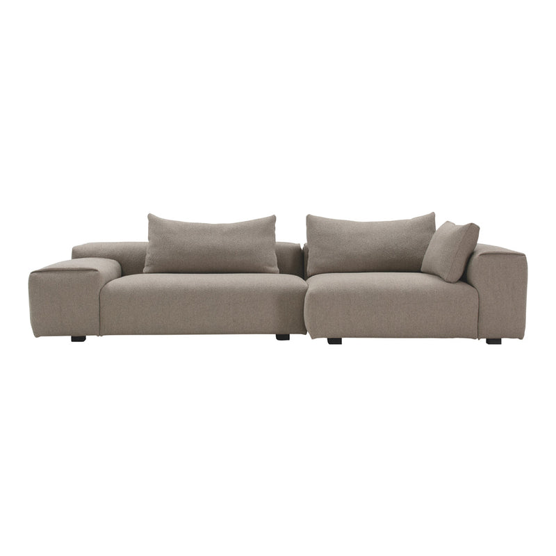 L-shaped sofa in soft beige fabric with smooth texture and minimalist design, perfect for contemporary decor.
