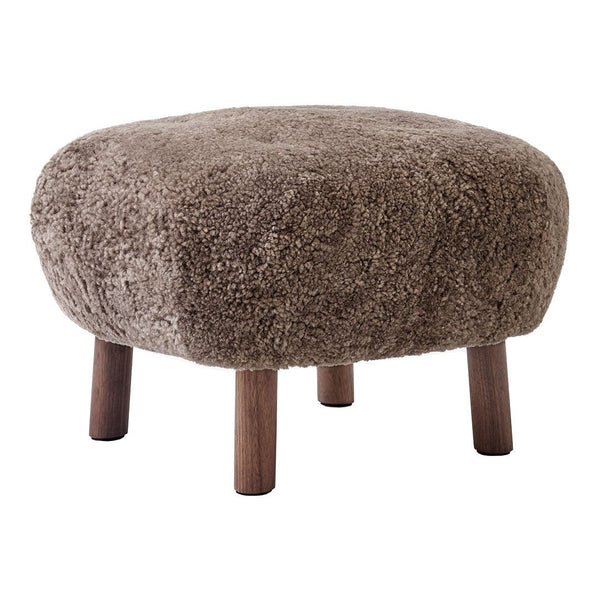 Brown fluffy ottoman with rounded shape and wooden legs, showcasing a cozy, textured surface.