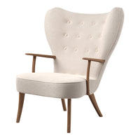 Cream upholstered armchair with tufted design and wooden legs in a mid-century modern style.