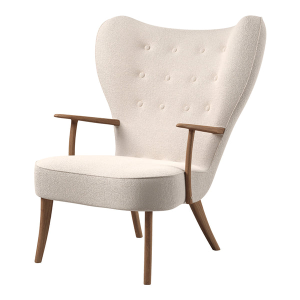 Cream upholstered armchair with tufted design and wooden legs in a mid-century modern style.