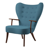 Mid-century modern chair in tranquil teal upholstery with button tufting and wooden legs.
