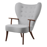 Light grey upholstered chair with button tufting and wooden arms, featuring a contemporary design.