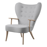 Light gray upholstered chair with tufted pattern and natural wood armrests and legs. Modern, elegant design for any decor.