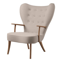Beige upholstered armchair with tufted buttons and wooden legs, featuring a modern, sleek design and smooth curves.