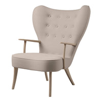 Beige upholstered chair with button detailing and natural wood legs, showcasing a minimalist, elegant design.