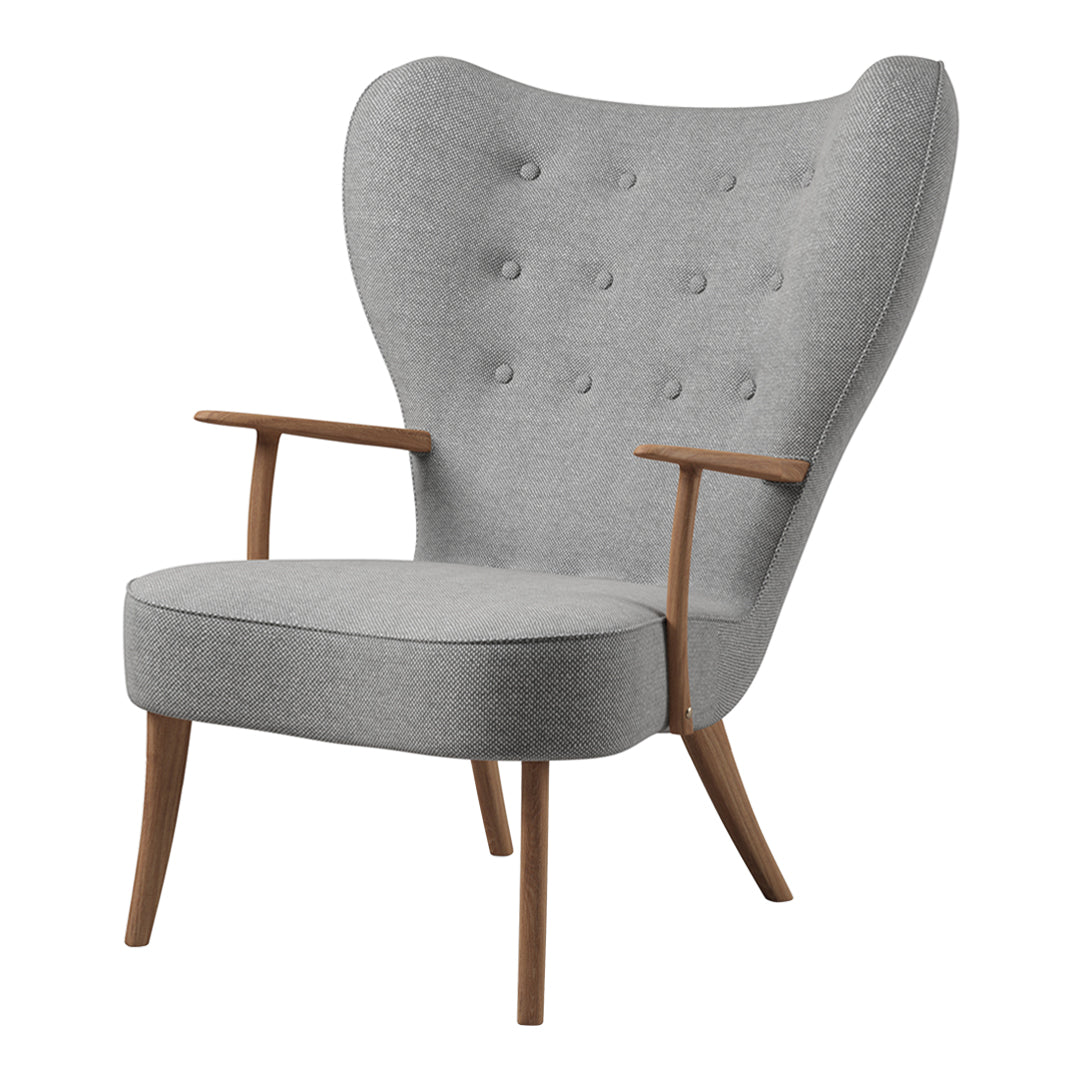 Light gray upholstered chair with tufted buttons and natural wood arms, featuring a modern wingback design.
