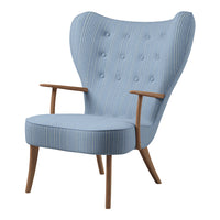 Light blue armchair with vertical stripes and tufted backrest, featuring natural wood armrest and legs.