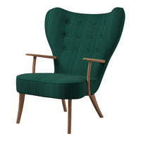 Vintage green armchair with ribbed texture and wooden legs, featuring a button-tufted backrest design.