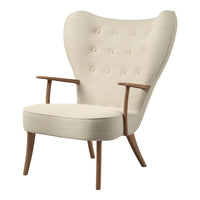 Cream upholstered chair with button detailing and natural wood arms, featuring a distinctive wingback design.