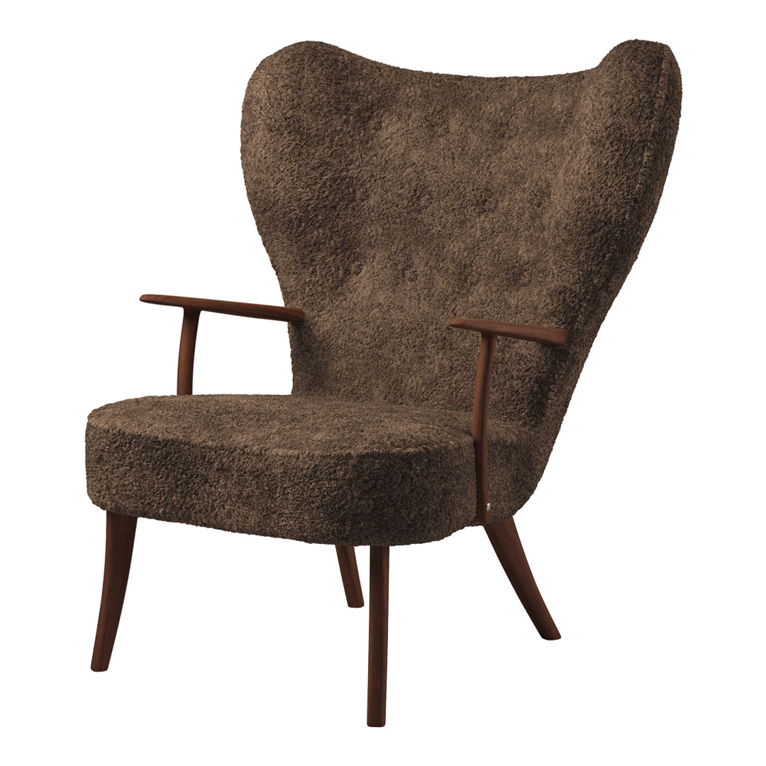 Brown tufted upholstery armchair with a distinctive wingback design and wooden legs. Perfect for modern decor.