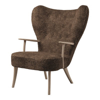 Brown textured armchair with a unique winged design and light wooden legs. Ideal for modern decor.