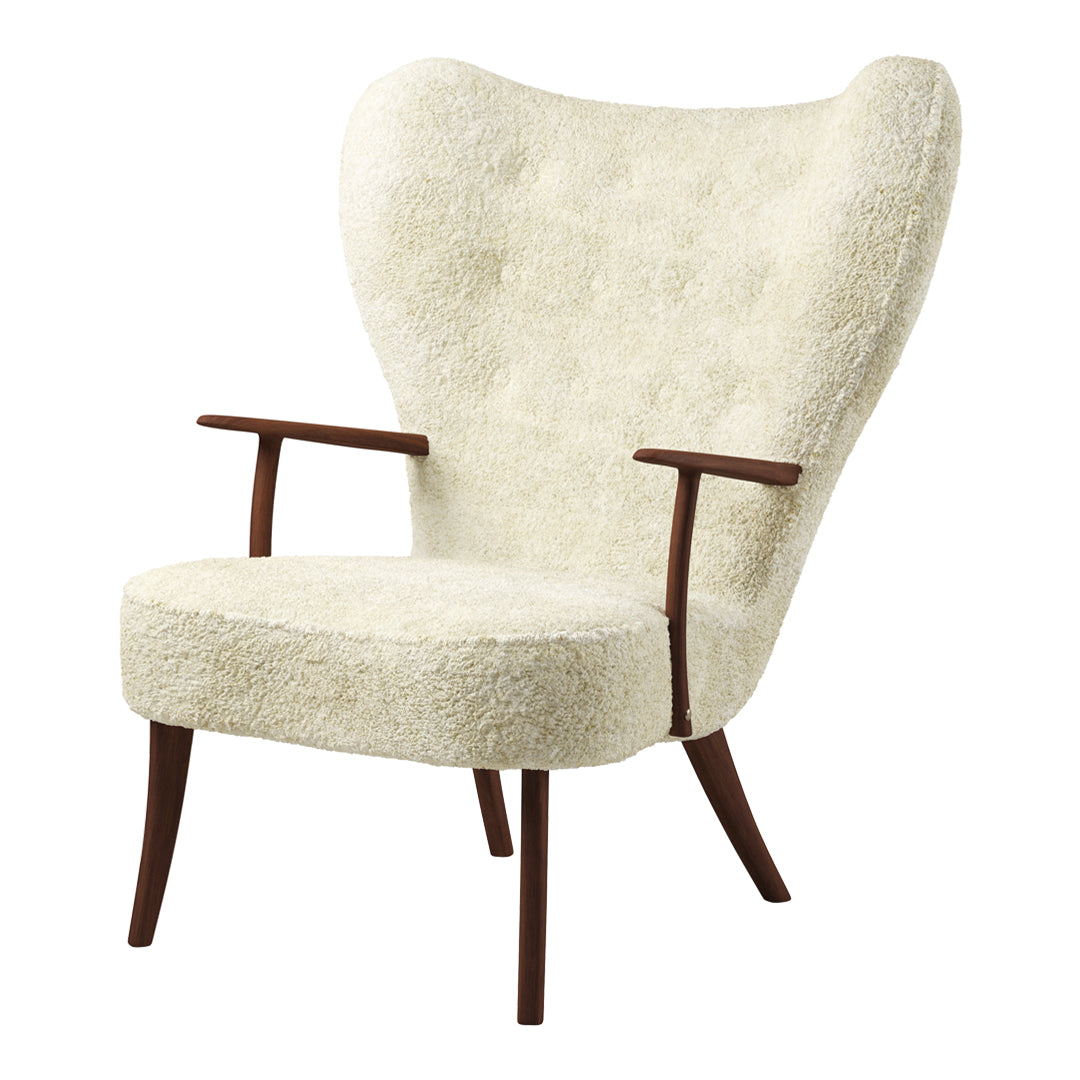Cream upholstered chair with tufted texture and wooden legs, featuring a stylish, curved back design.
