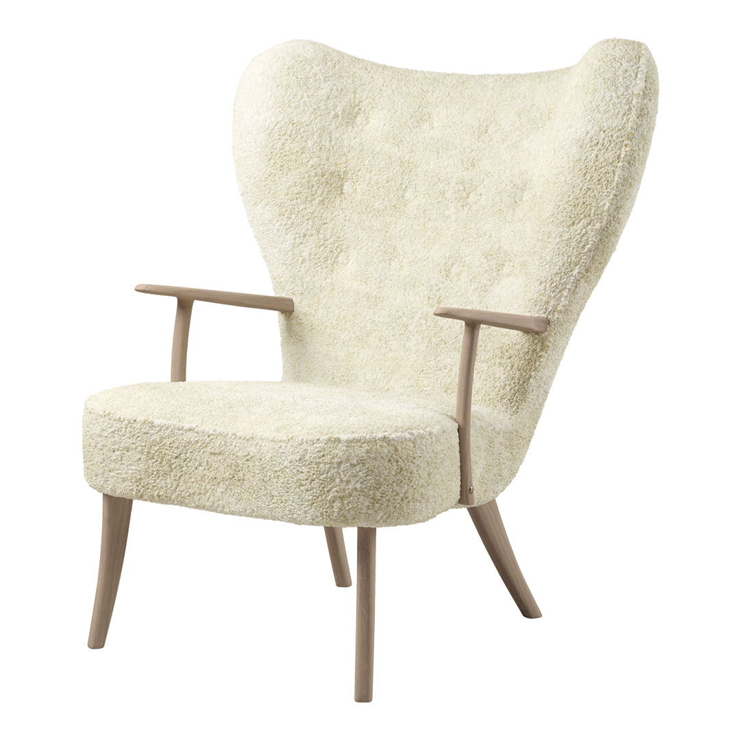 Cream-colored armchair with a textured, fluffy upholstery and wooden legs, featuring a stylish, classic silhouette.