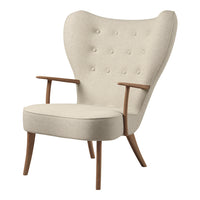 Beige upholstered chair with button tufting and wooden legs, featuring a unique wingback design.