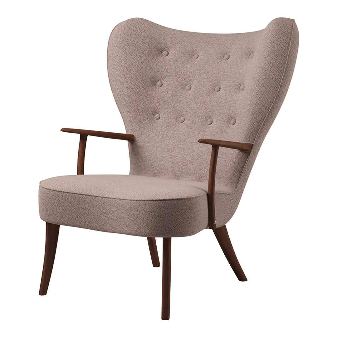 Light pink upholstered chair with button-tufted back, wooden arms, and tapered legs in a mid-century modern style.