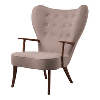 Light pink upholstered chair with button-tufted back, wooden arms, and tapered legs in a mid-century modern style.