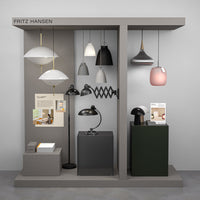 Collection of modern lamps in white, black, gray, and soft pink hues with various geometric patterns on display.