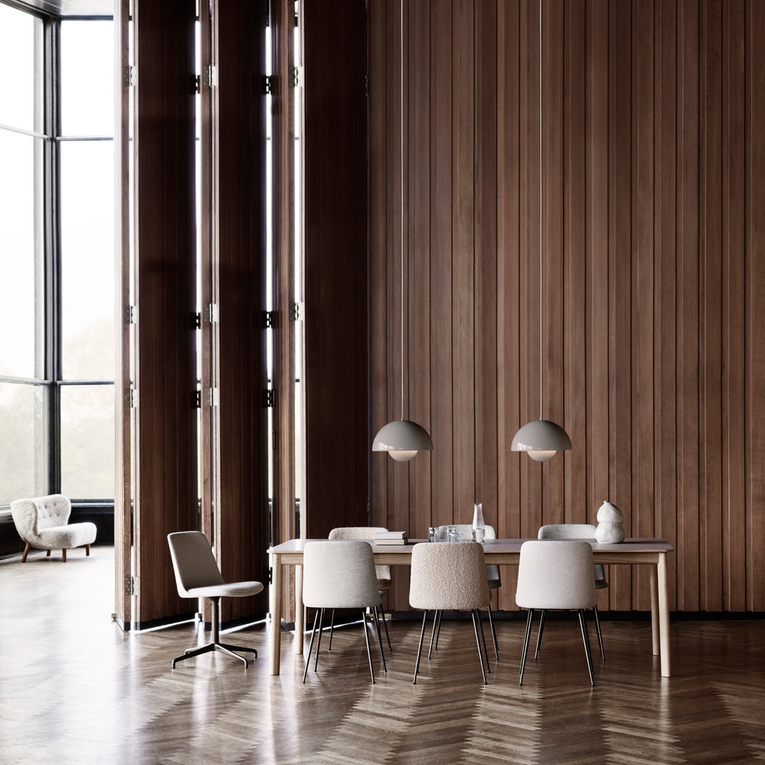 Modern dining room featuring warm wood tones, neutral chairs, and geometric flooring patterns. Elegant and minimalist design.