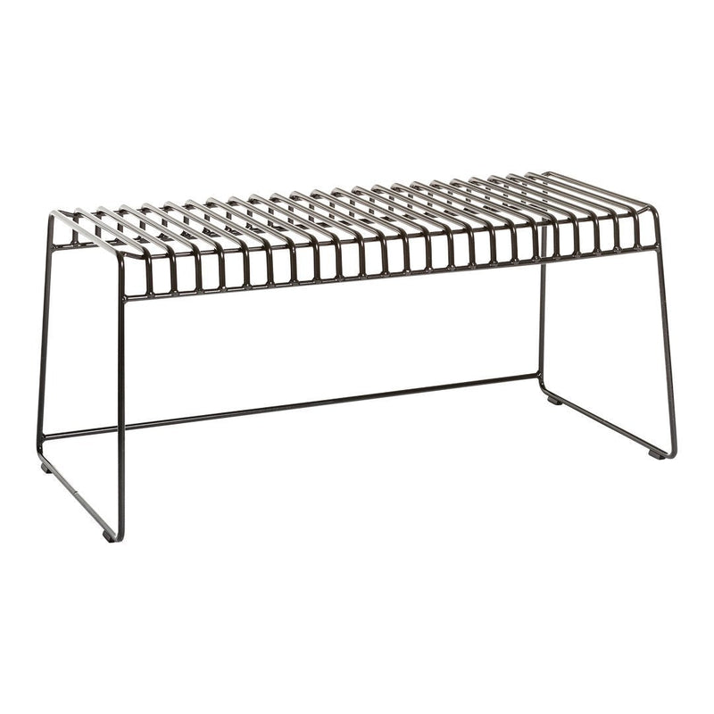 Black metal bench with a geometric, slatted design, featuring a sleek and modern aesthetic.