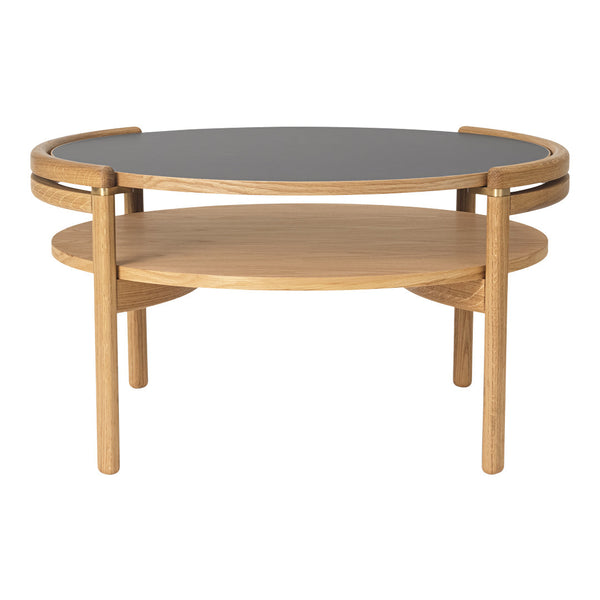 Elegant round coffee table with a black top and natural oak wood base, showcasing a minimalist design.