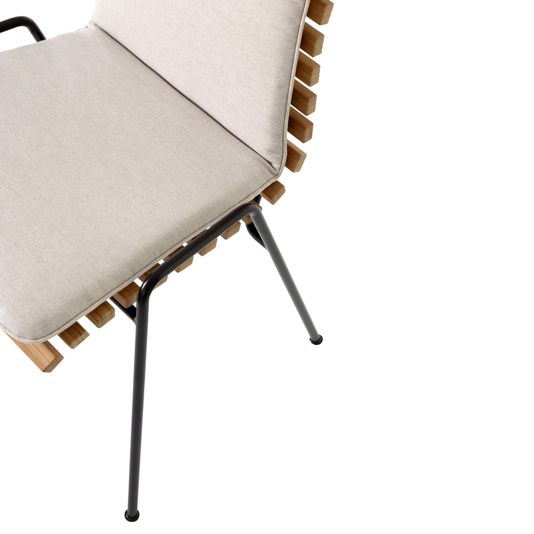 Beige cushion and wooden slat design on a black metal frame chair. Modern and minimalistic style.
