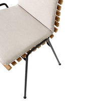 Beige cushion and wooden slat design on a black metal frame chair. Modern and minimalistic style.