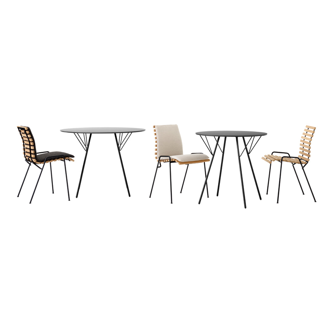 Modern dining set featuring black and beige chairs with wooden patterns and a sleek round glass table on black legs.
