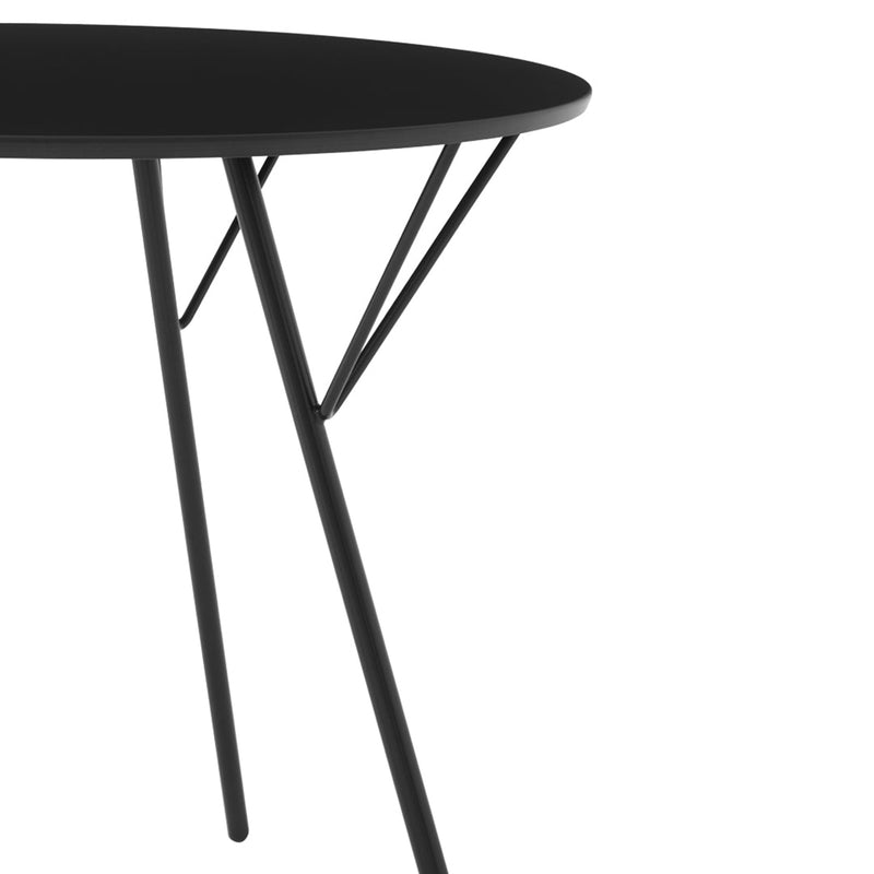 Black round table with sleek, minimalist design and angular black legs. Perfect for modern decor.