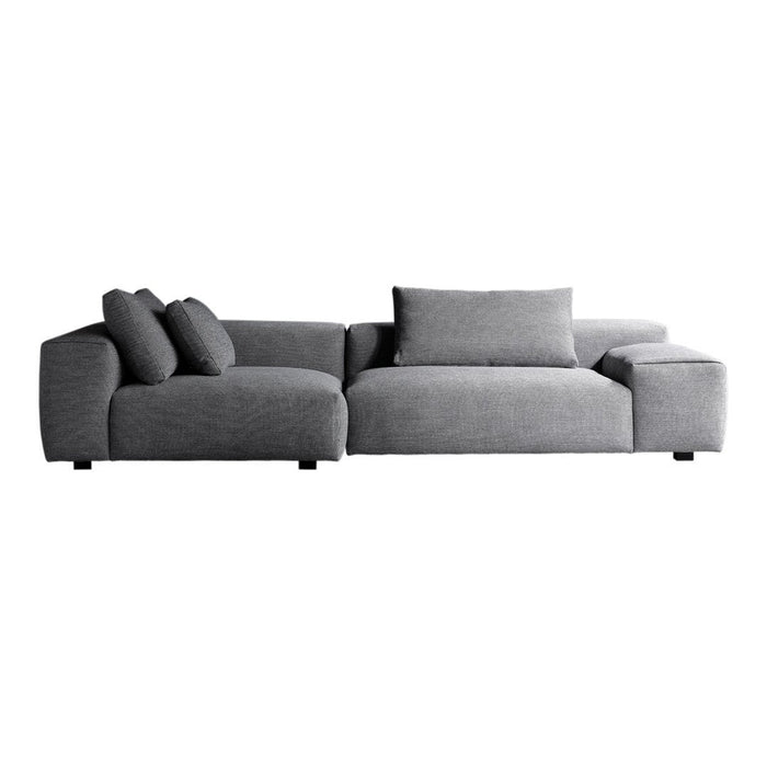 Modern grey sectional sofa with soft, textured fabric and plush cushions, ideal for contemporary living spaces.