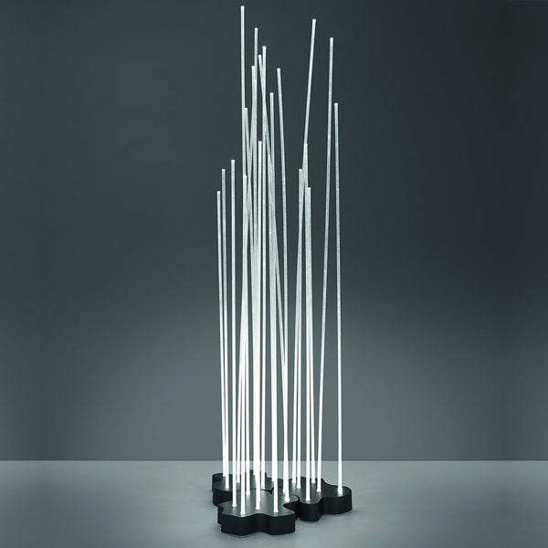 Modern metal sculpture with slim, vertical silver rods on a black base, showcasing a sleek, minimalist design.