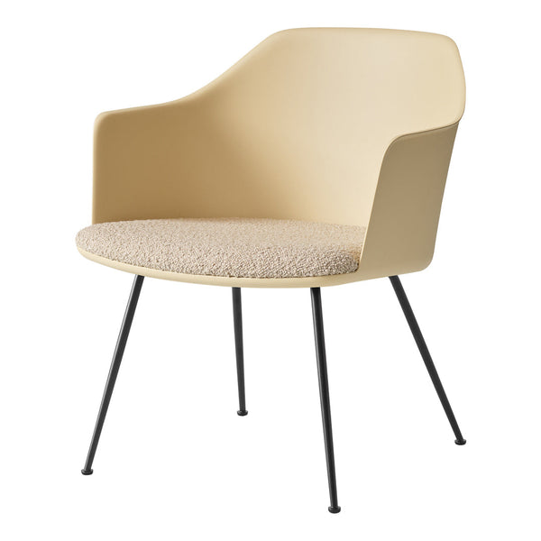 Beige armchair with a textured cream seat, featuring sleek black metal legs for a modern touch.