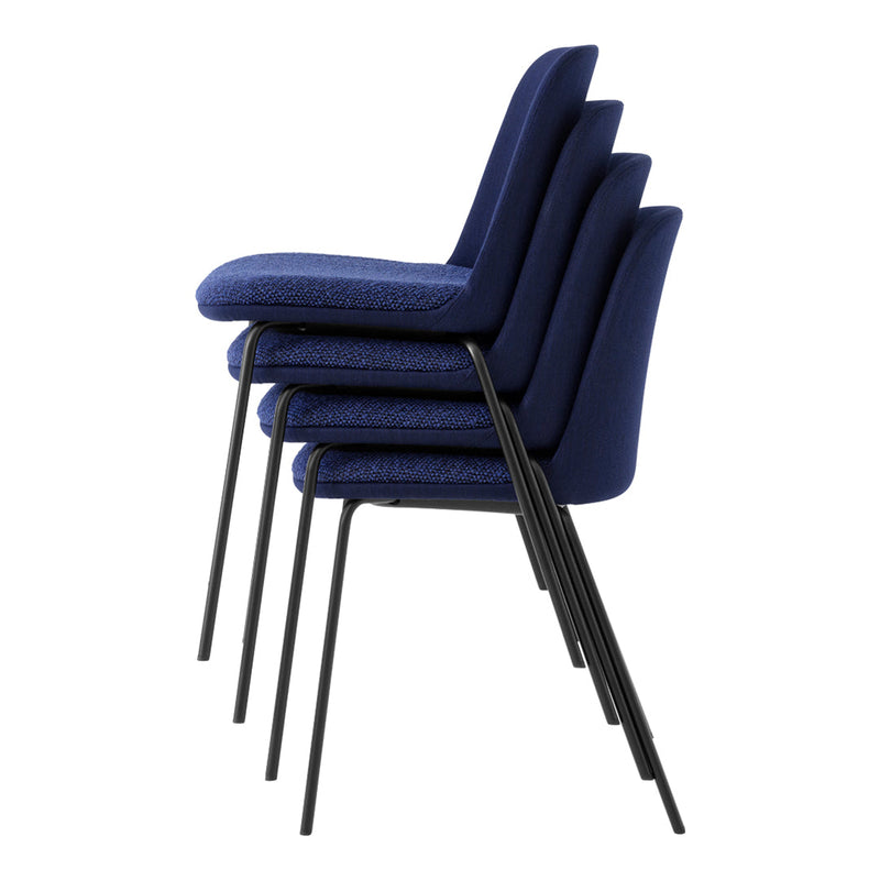 Stacked chairs in a deep navy blue fabric with a textured pattern and sleek black metal legs.