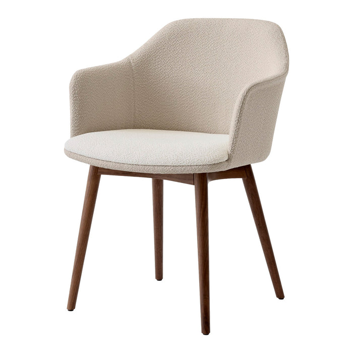 Beige upholstered chair with a smooth finish and natural wood legs. Soft textures and minimalist design.