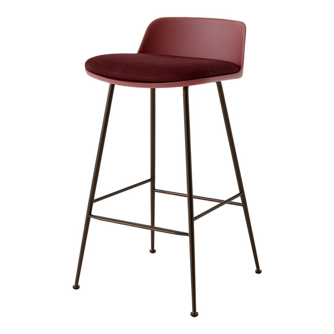 Modern burgundy velvet bar stool with sleek brown metal legs. Minimalist design, perfect for contemporary decor.