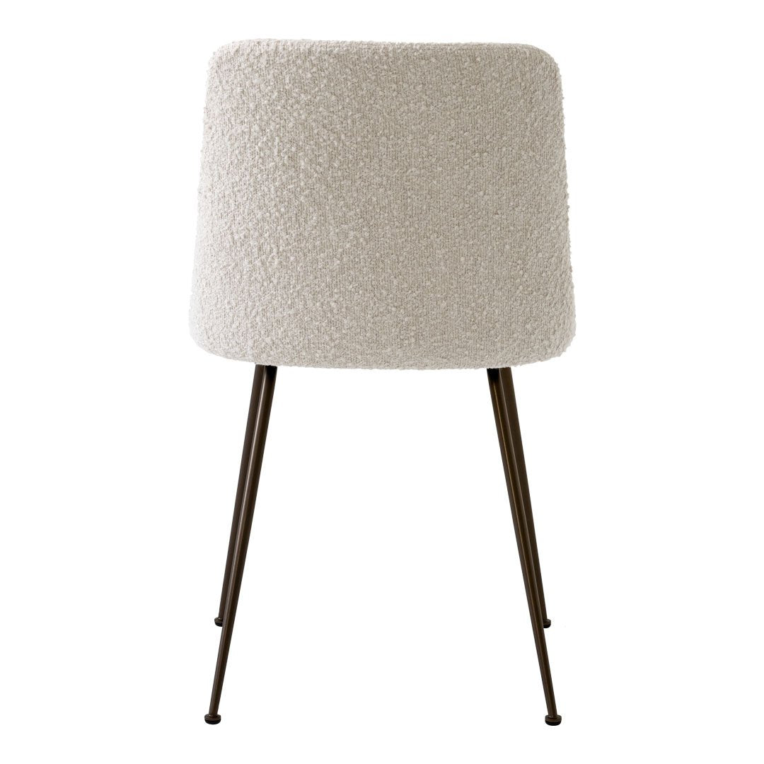 Soft white textured upholstery with sleek black metal legs for a modern, minimalist chair design.