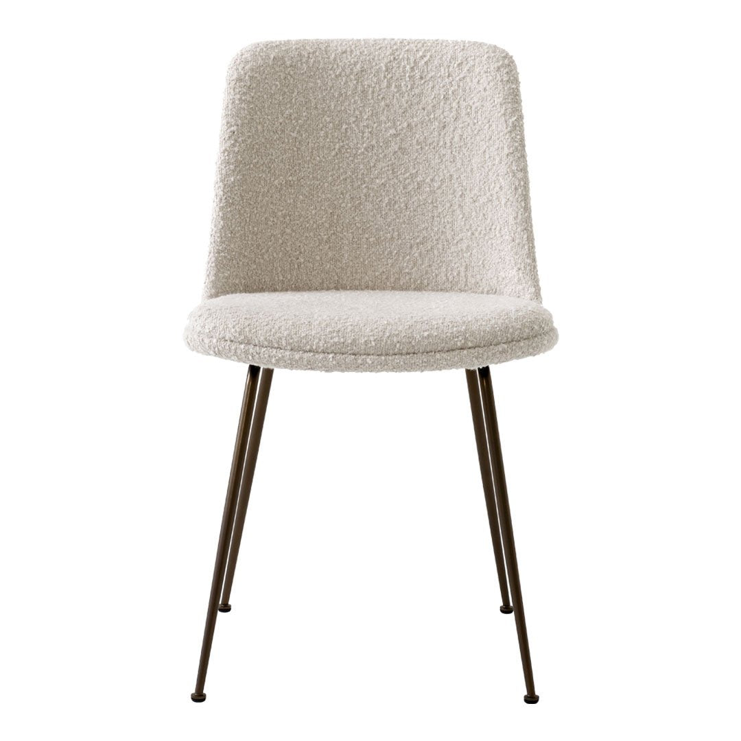 Cream upholstered chair with textured, fluffy fabric and sleek metal legs. Perfect for modern decor.