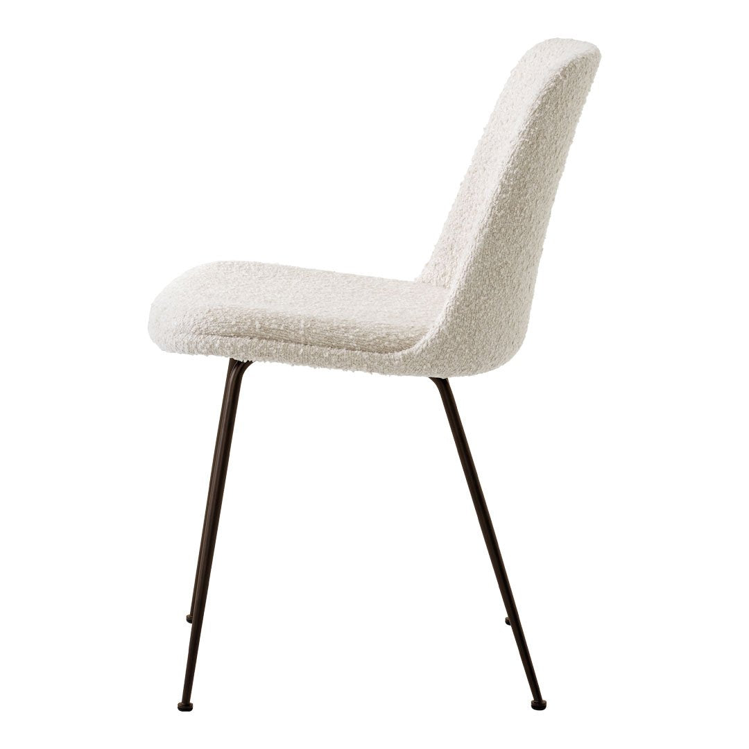 Cream upholstered chair with a textured surface and sleek black metal legs. Perfect for modern decor.