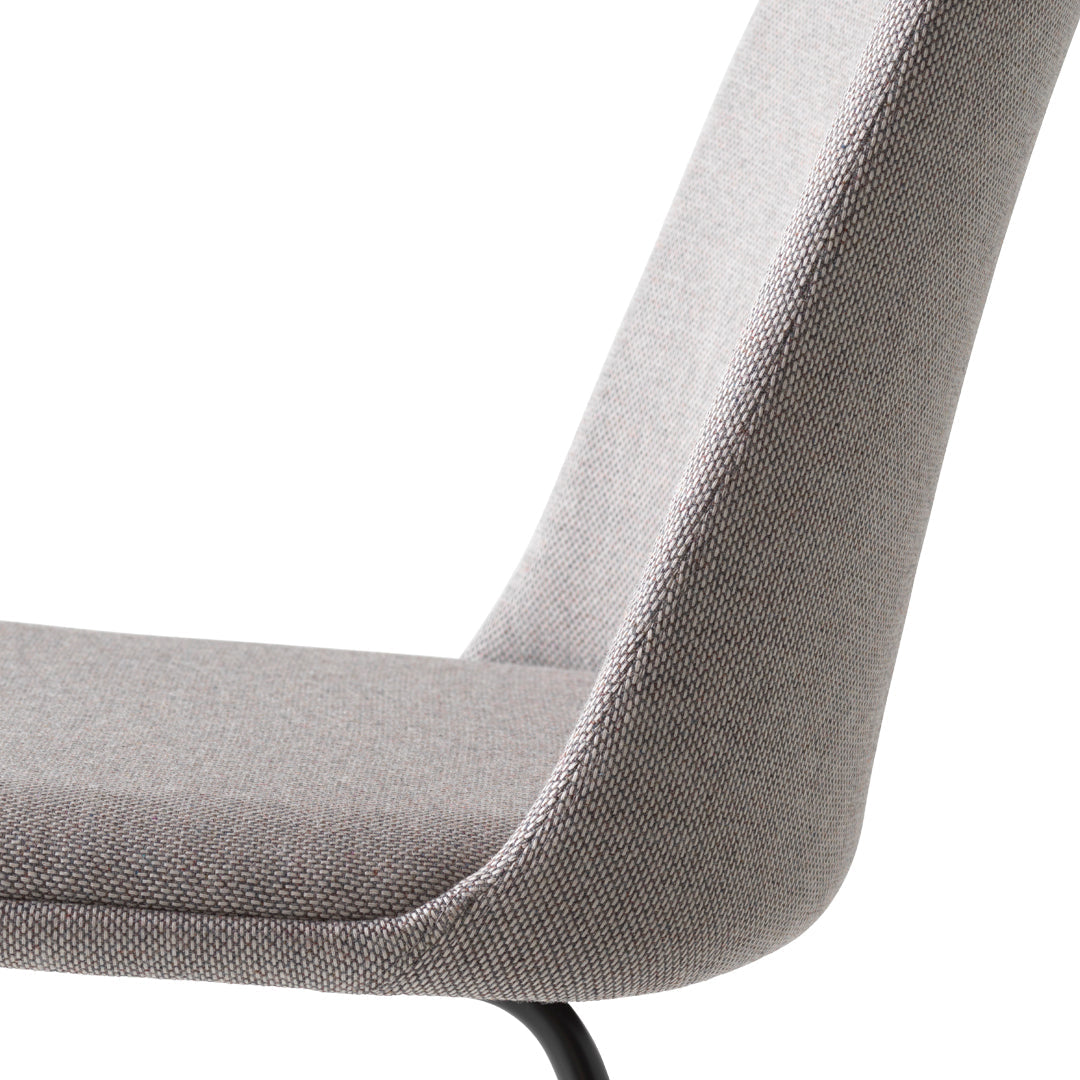 Gray upholstered chair with a sleek design and subtle textured pattern on the fabric.