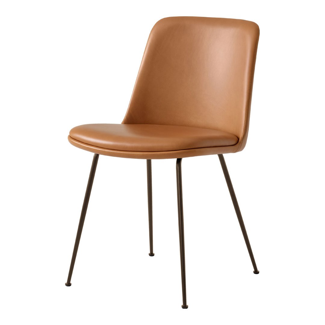 Tan upholstered chair with a smooth finish and black metal legs, perfect for modern decor.