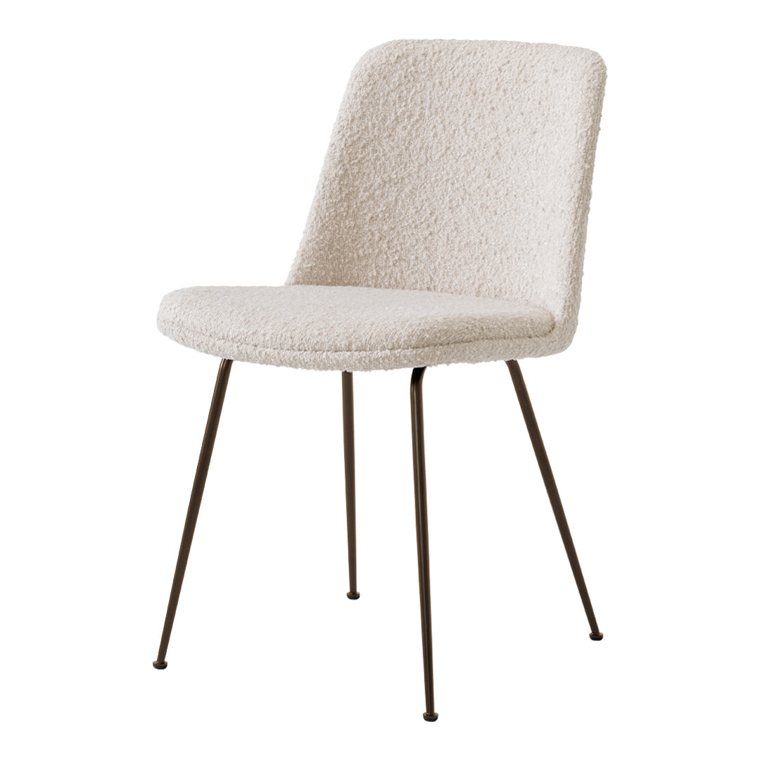 Cream textured chair with sleek black metal legs, featuring a minimalist design and soft, inviting upholstery.