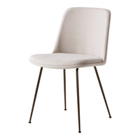 Simple beige chair with a smooth, upholstered seat and slender black metal legs. Elegant and modern design.
