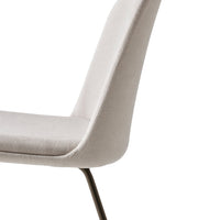 Light gray upholstered dining chair with sleek design and subtle texture, perfect for modern decor.