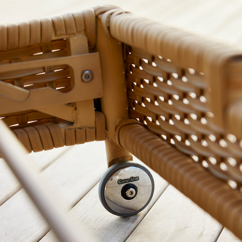 Light brown woven pattern with a glossy black wheel, showcasing a sleek, modern design for outdoor furniture.