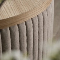 Beige ribbed fabric with a light wooden top, showcasing a modern and elegant design. Perfect for contemporary decor.