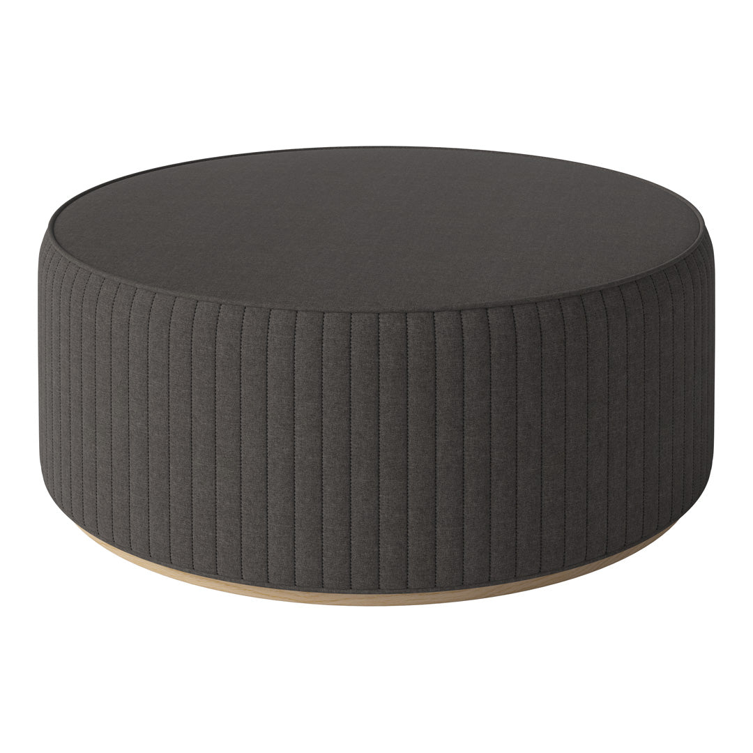 Round dark gray ottoman with vertical ribbed texture and wooden base, perfect for modern decor.