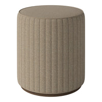 Beige upholstered stool with vertical ribbed pattern and circular wooden base. Ideal for modern decor.