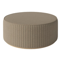 Round beige ottoman with vertical ribbed pattern and smooth top surface, perfect for modern decor.