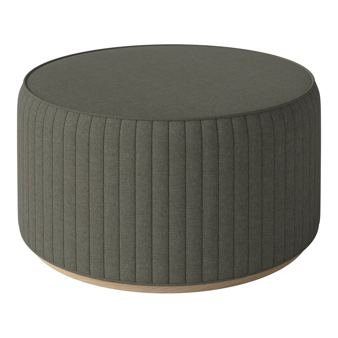 Round green ottoman with vertical ribbed texture and light wooden base, perfect for modern decor.